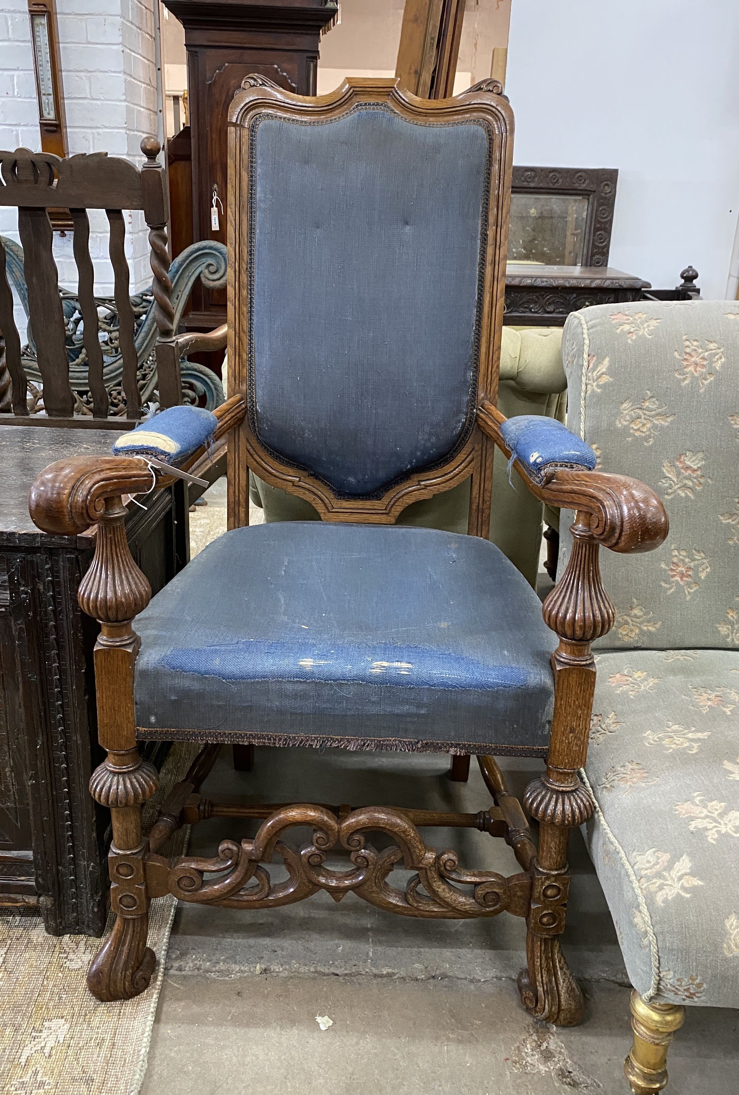 A Carolean style oak upholstered open armchair, width 65cm, depth 55cm, height 118cm